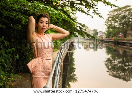 Urban portrait of young Asian woman.