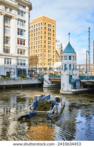 Urban River Cleaning Boat and Cityscape Architecture