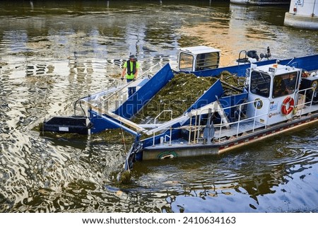 Urban River Cleanup Operation, Milwaukee - Worker on Debris Collection Boat
