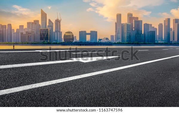 Urban road asphalt pavement and skyline of\
Hangzhou architectura