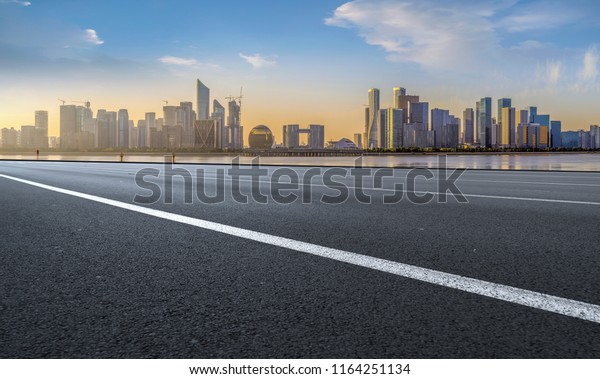 Urban road asphalt pavement and skyline of\
Hangzhou architectura