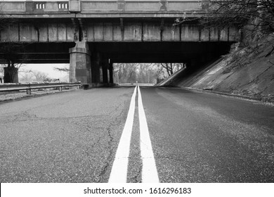 Urban Road With Bridge Overpass. Black Asphalt Pavement Street Road With Yellow Road Markings. Abstract Street Urban Street Photography. 