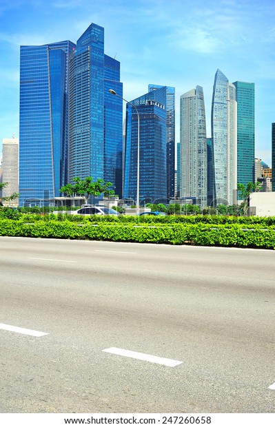 Urban road in Singapore. Downtown Core of\
Singapore on the\
background