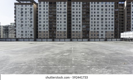 Urban Rooftop Car Park On City Background