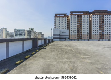 Urban Rooftop Carpark On City Background