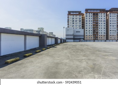 Urban Rooftop Carpark On City Background