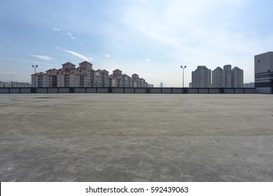 Urban Rooftop Carpark On City Background