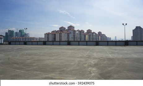 Urban Rooftop Carpark On City Background