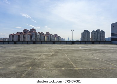 Urban Rooftop Carpark On City Background