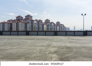 Urban Rooftop Carpark On City Background