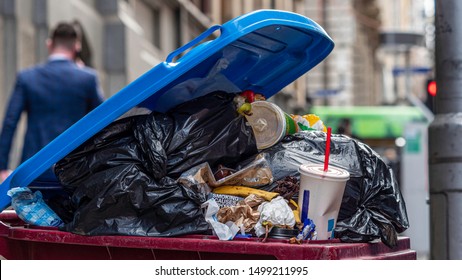 Urban Rubbish Bin Overflowing In A Populous City. Food Scraps, Plastic Waste, Single Use Bags. Shows Recycling Problems Or Issues, Waste Management, Etc. Melbourne, Australia - September 2019: 