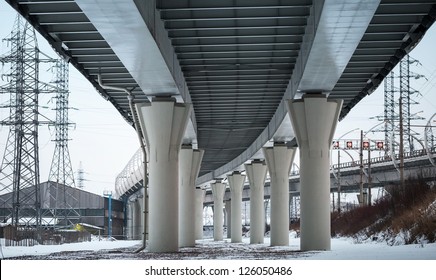 Urban scene with bottom view of steel automotive bridge