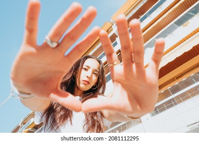 Urban Shot Of A Modeling Young African Woman With Long Hair Smiling And Making Poses To Camera. City Urban Concept. Happy Day On The City, White Shirt Blue Jeans. Modern Outfit Styling. Street Life.