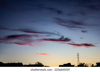 urban sky with maroon colored clouds, after sunset