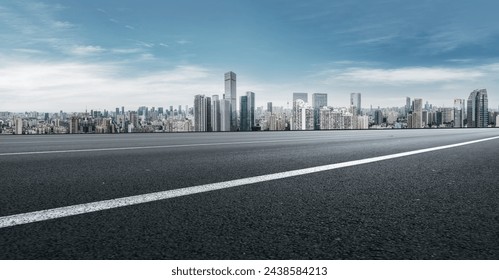 Urban Skyline and Clear Road Under Blue Sky
