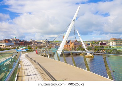 Urban skyline of Derry city (also called Londonderry) in northern Ireland with the famous "Peace Bridge" (Europe - Northern Ireland)