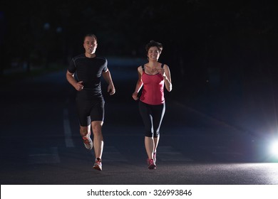 Urban Sports, Healthy Couple Jogging In The City At Early Morning In Night