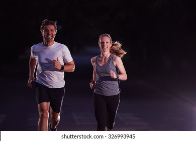 Urban Sports, Healthy Couple Jogging In The City At Early Morning In Night