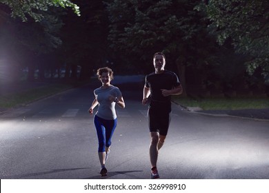 Urban Sports, Healthy Couple Jogging In The City At Early Morning In Night