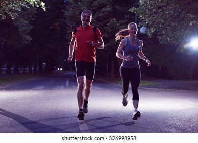 Urban Sports, Healthy Couple Jogging In The City At Early Morning In Night