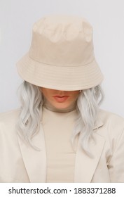 Urban street style Blonde. Details of everyday look. Casual beige aesthetic outfit and accessories. Bucket hat. Trendy Minimalist fashion