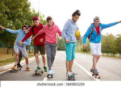 urban teen boys on skateboards,young boys riding in the park on a skateboard. city style. urban people. learns to ride, friendship - Powered by Shutterstock