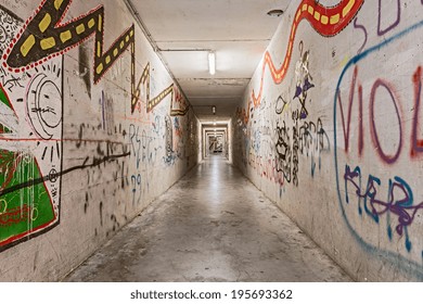 urban underground tunnel with graffiti - light and shadows on grunge pedestrian underpass - dark narrow subway alley  - Powered by Shutterstock