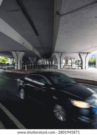 Urban underpass with speeding car capturing motion and modern infrastructure