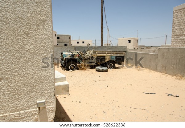 URBAN WARFARE TRAINING FACILITY, ISRAEL - JUNE
4, 2013: Abandoned Middle Eastern town. Derelict city, ruined in
battles. Bombed city, war scene, ruined military vehicle. Counter
terror training.