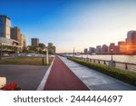 Urban Waterfront Pathway with Cityscape at Sunrise