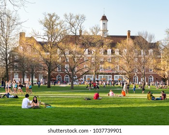 URBANA, ILLINOIS - APRIL 17, 2016:  Students Walk And Sit Outside On Quad Lawn Of University Of Illinois College Campus In Urbana Champaign