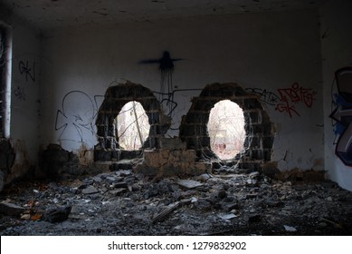 Urbex, Scary Abandoned And Dark Room With Broken Brick Wall With Two Holes