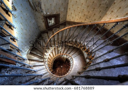 Urbex (Urban Exploration): spiral staircase in an abandoned villa