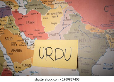 Urdu word written on a sticky note with Pakistan Map in the background