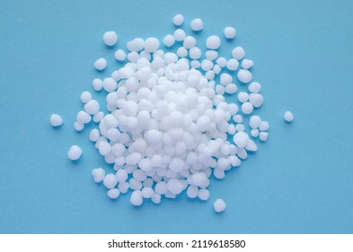 Urea Granules On A Blue Background, Space For Text, Top View. Nitrogen Mineral Fertilizer - Urea. Ammonium Nitrate, A Salt Of Ammonia And Nitric Acid, Is Used For Plant Nutrition, Top View.