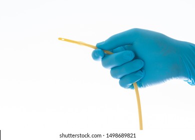 urethral catheter hold on blue glove hand on white background