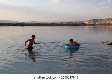 Urfa, Turkey 2021. Karahan Region. Syrian Refugee Children Playing In The Lake.