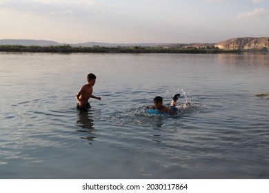 Urfa, Turkey 2021. Karahan Region. Syrian Refugee Children Playing In The Lake.