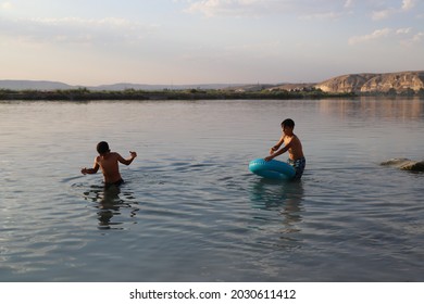 Urfa, Turkey 2021. Karahan Region. Syrian Refugee Children Playing In The Lake.