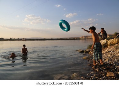 Urfa, Turkey 2021. Karahan Region. Syrian Refugee Children Playing In The Lake.