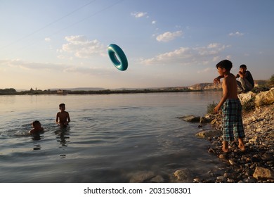 Urfa, Turkey 2021. Karahan Region. Syrian Refugee Children Playing In The Lake.