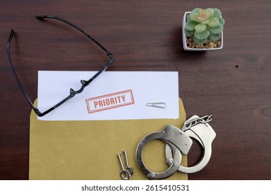 Urgent Dispatch: Priority Document Emerging from Envelope on Wooden Desk