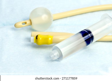 Urinary catheter with fill syringe on sterile drape.