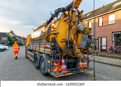 Urk, The Netherlands - September 07, 2019: Workers With Specialized Truck Cleaning Sewer System In Residential Area