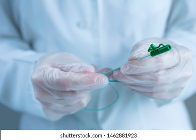 Urological catheter in the hands of a doctor. Close-up.
