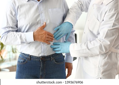 Urologist Examining Male Patient In Clinic