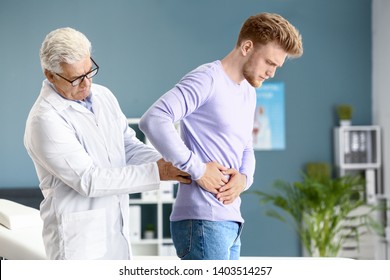 Urologist Examining Male Patient In His Office