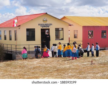 UROS ISLAND, PERU - MAY 20: Group Of Unidentified Children And Teacher Stand By The School In The Morning In The Floating Village Of Uros Islands On Lake Titicaca On May 20, 2013, Peru. 