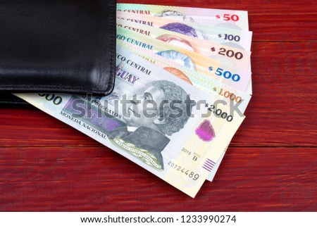 Uruguayan money in the black wallet 
