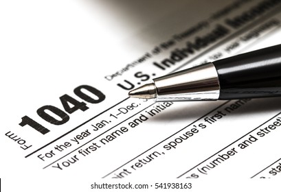 US 1040 Tax Form With Pen, And Coins